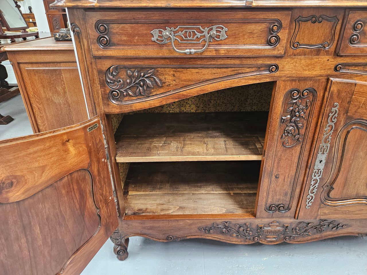 Attractive French Walnut Louis XV style two door two drawer sideboard featuring beautiful carving. Circa: 1930's. It has been sourced from France and it is in good original detailed condition.