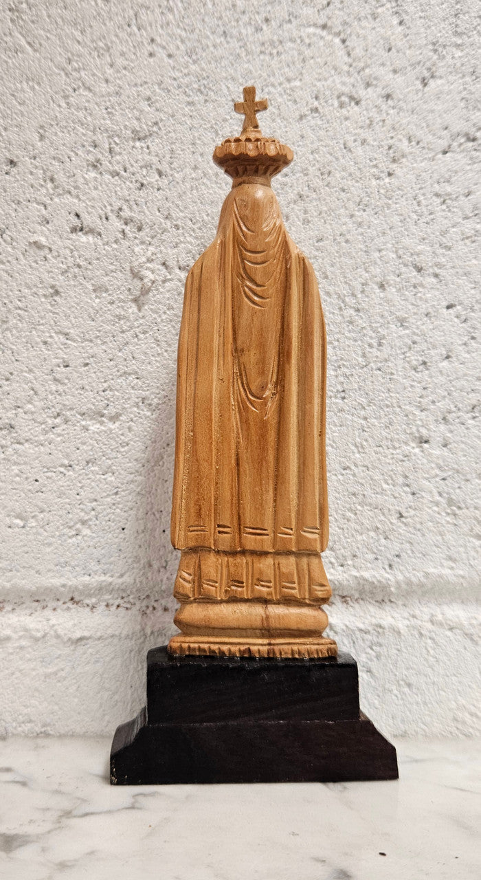 Vintage Olivewood statue of praying Virgin Mary on dark wooden plinth. Condition comensurate with age, please view photos as they help form part of the description.