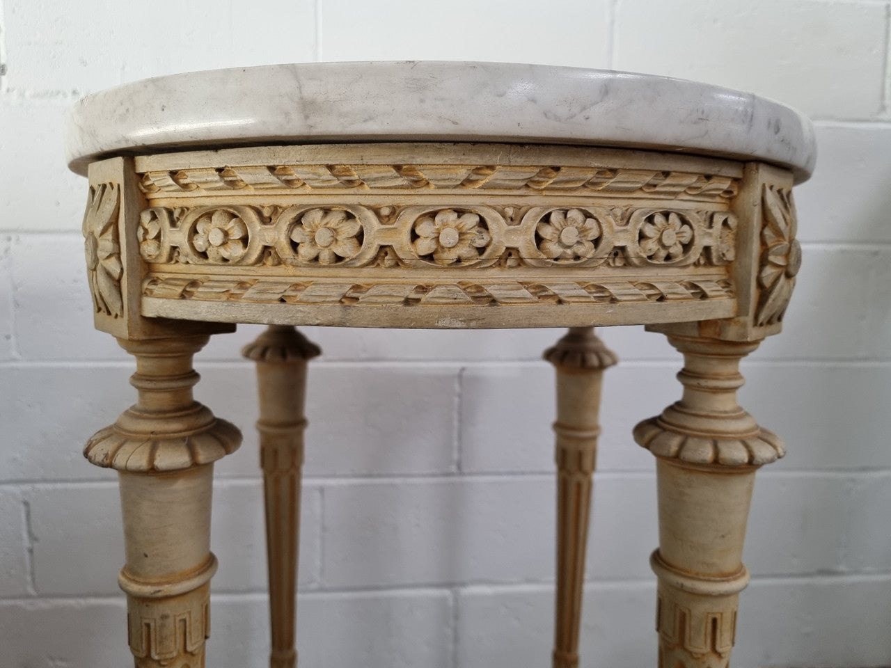 Louis XVI style round side table with original paint and a beautiful thick marble top. It is in good original detailed condition.