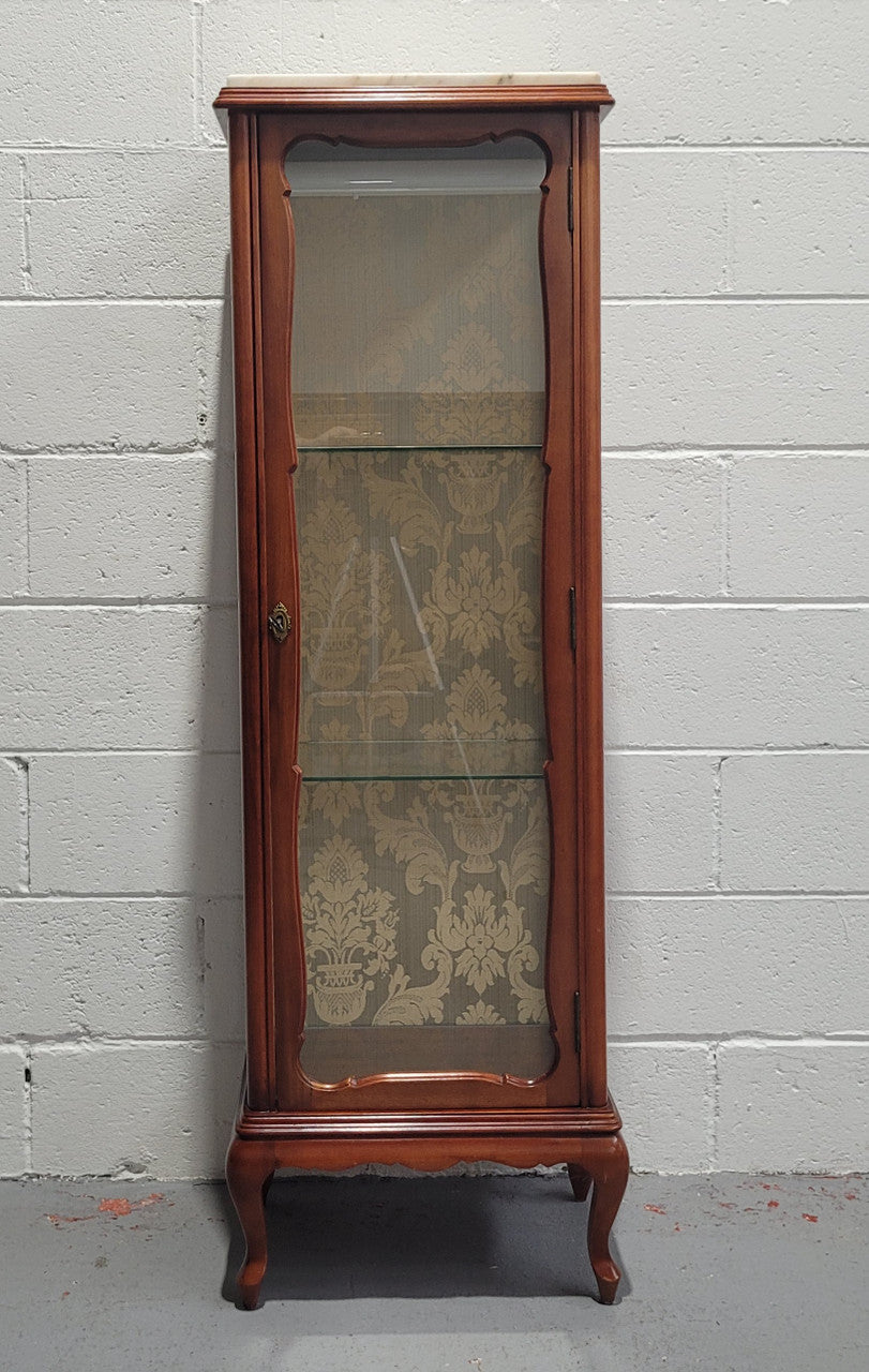 French Louis XV style small scaled display cabinet with marble top. It is of pleasing proportions with a lovely olive french damask fabric back and two glass shelves. In good original detailed condition.