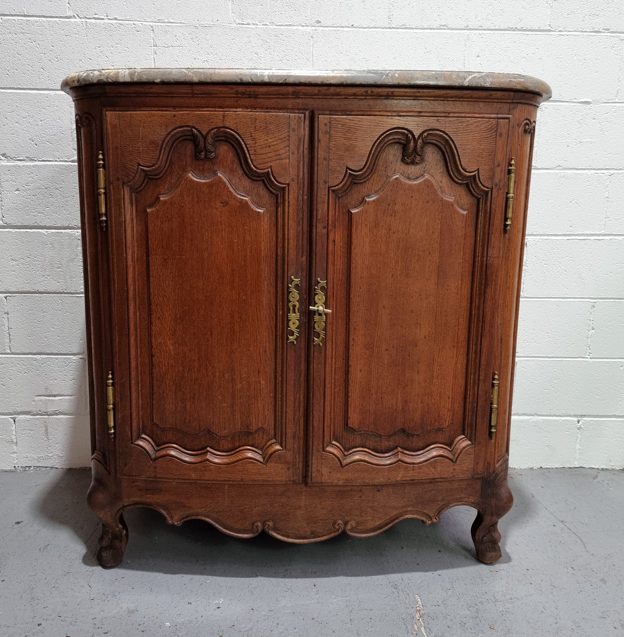 Rare 19th Century French Oak and marble top oval buffet / cabinet. Stunning thick marble top and decorative handles. In good original detailed condition.
