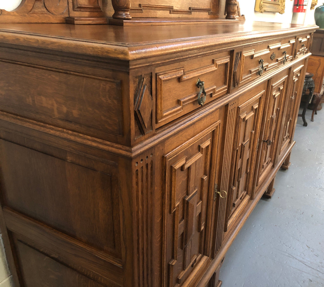 Beautiful carved French Oak four-door buffet with three drawers and lots of room for storage in good original detailed condition.