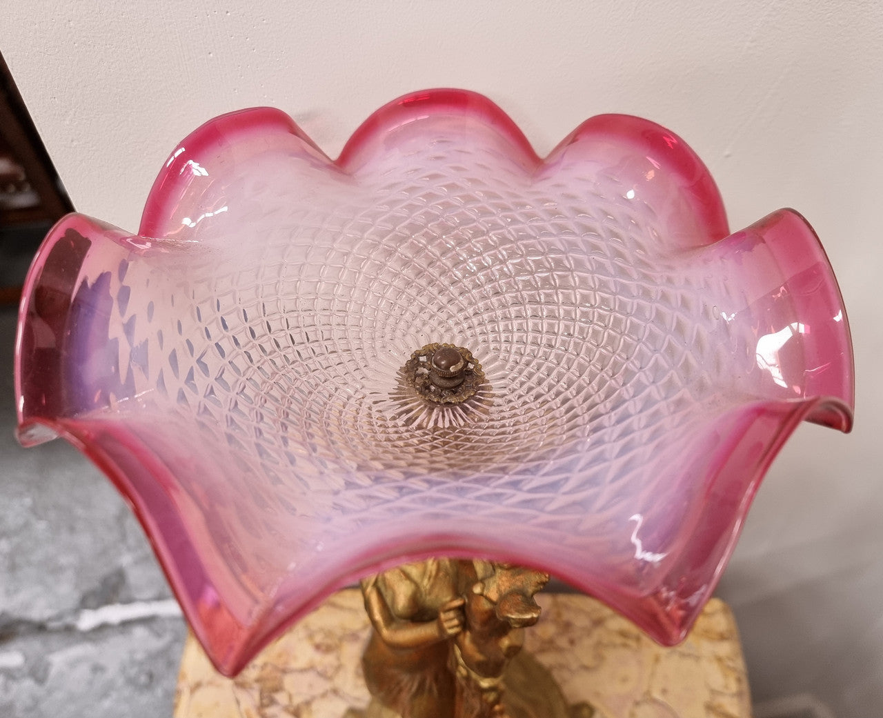 Late Victorian spelter table Centerpiece/comport featuring a woman holding an opalescent and ruby glass bowl. In good original condition with no damage to the ruby bowl.