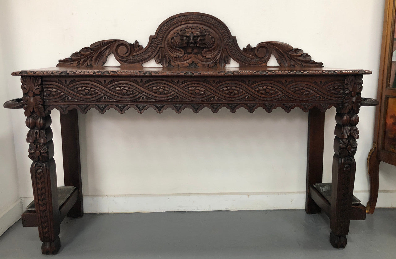 Superb 19th Century Gothic style hall/console table. It has umbrella and walking stick holders on both sides. In good original detailed condition.