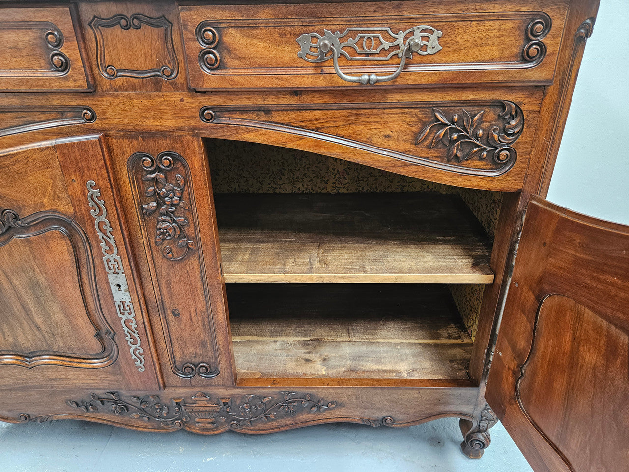 Attractive French Walnut Louis XV style two door two drawer sideboard featuring beautiful carving. Circa: 1930's. It has been sourced from France and it is in good original detailed condition.