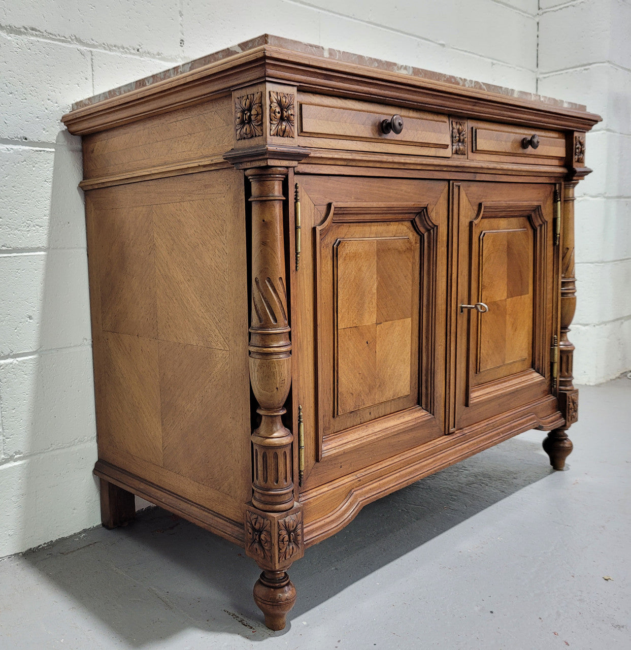 Stunning French walnut Henry II style marble top side cabinet with two drawers and two shelves inside. In good original detailed condition.