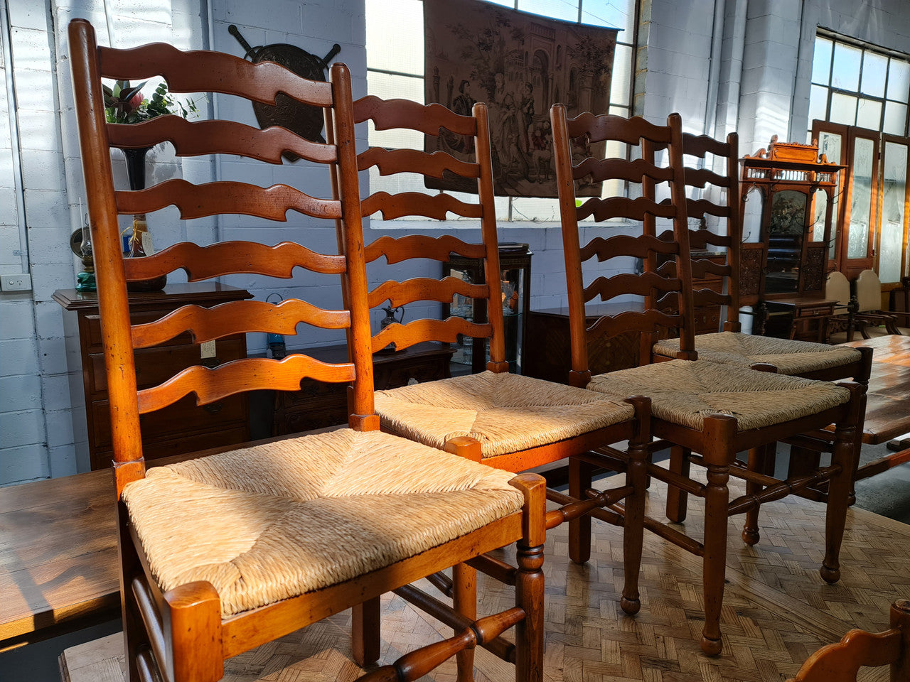 Charming set of eight Cherry Wood ladder back dining chairs. They are in good original detailed condition.