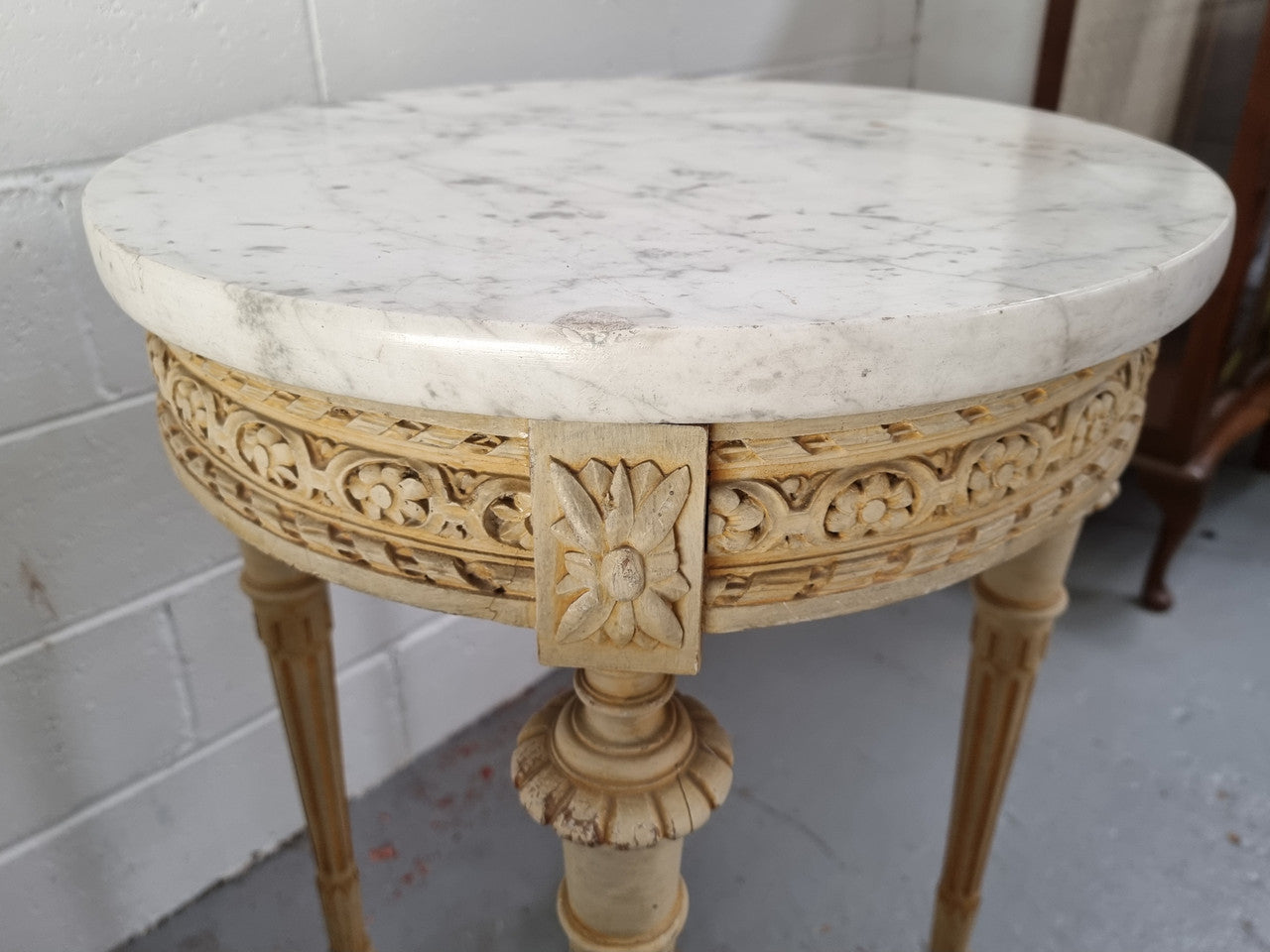 Louis XVI style round side table with original paint and a beautiful thick marble top. It is in good original detailed condition.
