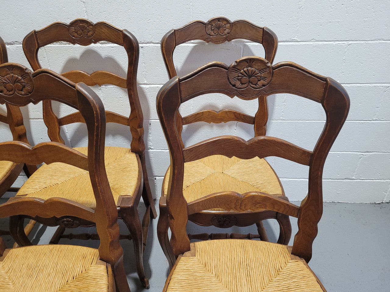 A stunning set of six French Louis XV Style oak dining chairs with rush seats in good original condition. All chairs have been detailed and re-glued where needed.