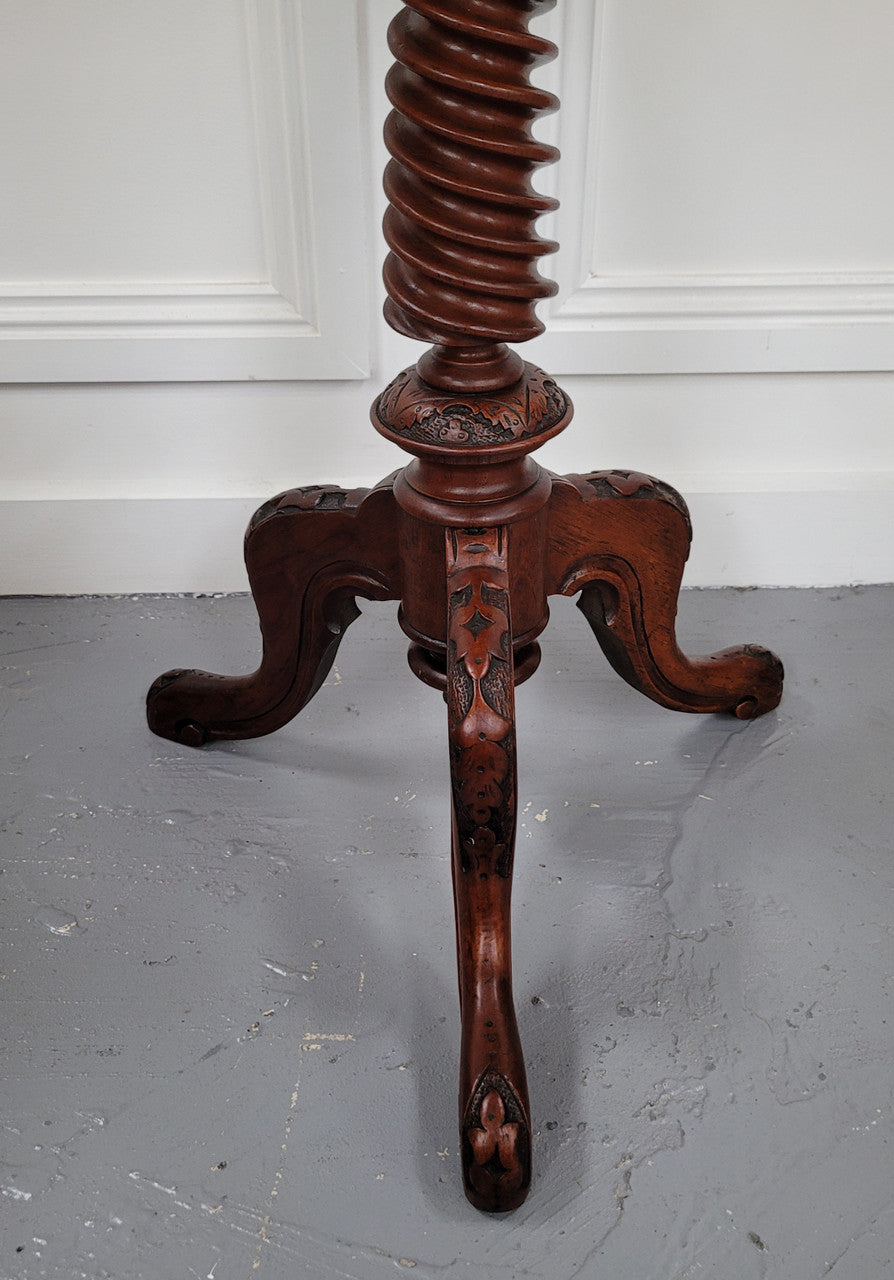Rare early Victorian Irish Burr Walnut wine table. It has a beautiful carvings and a stunning burr walnut top, on a barley twist column and three shaped legs. It has been sourced locally and is in good original detailed condition. We also have a second table being sold separately which when together make a matched pair.