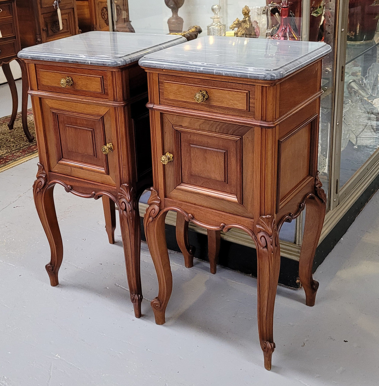 Pair of Walnut Louis XV style grey marble top bedside cabinets. Single drawer, one cupboard and lovely French cabriole legs. They have been sourced from France and are in good original condition.