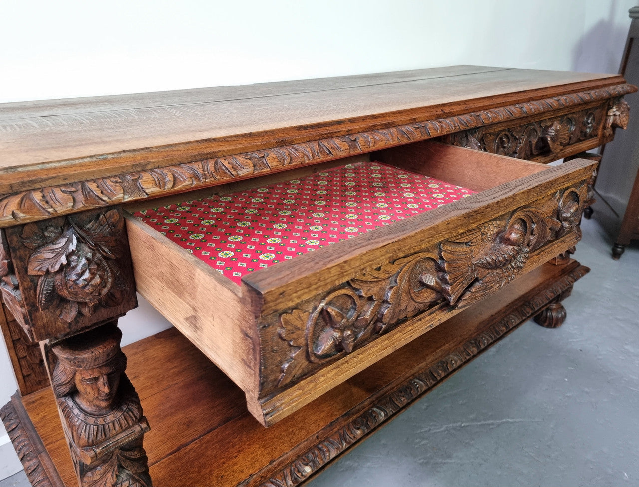 19th Century French Oak Henry the 2nd style console/side table/ TV unit with two drawer with beautiful carvings. It is in good original detailed condition.