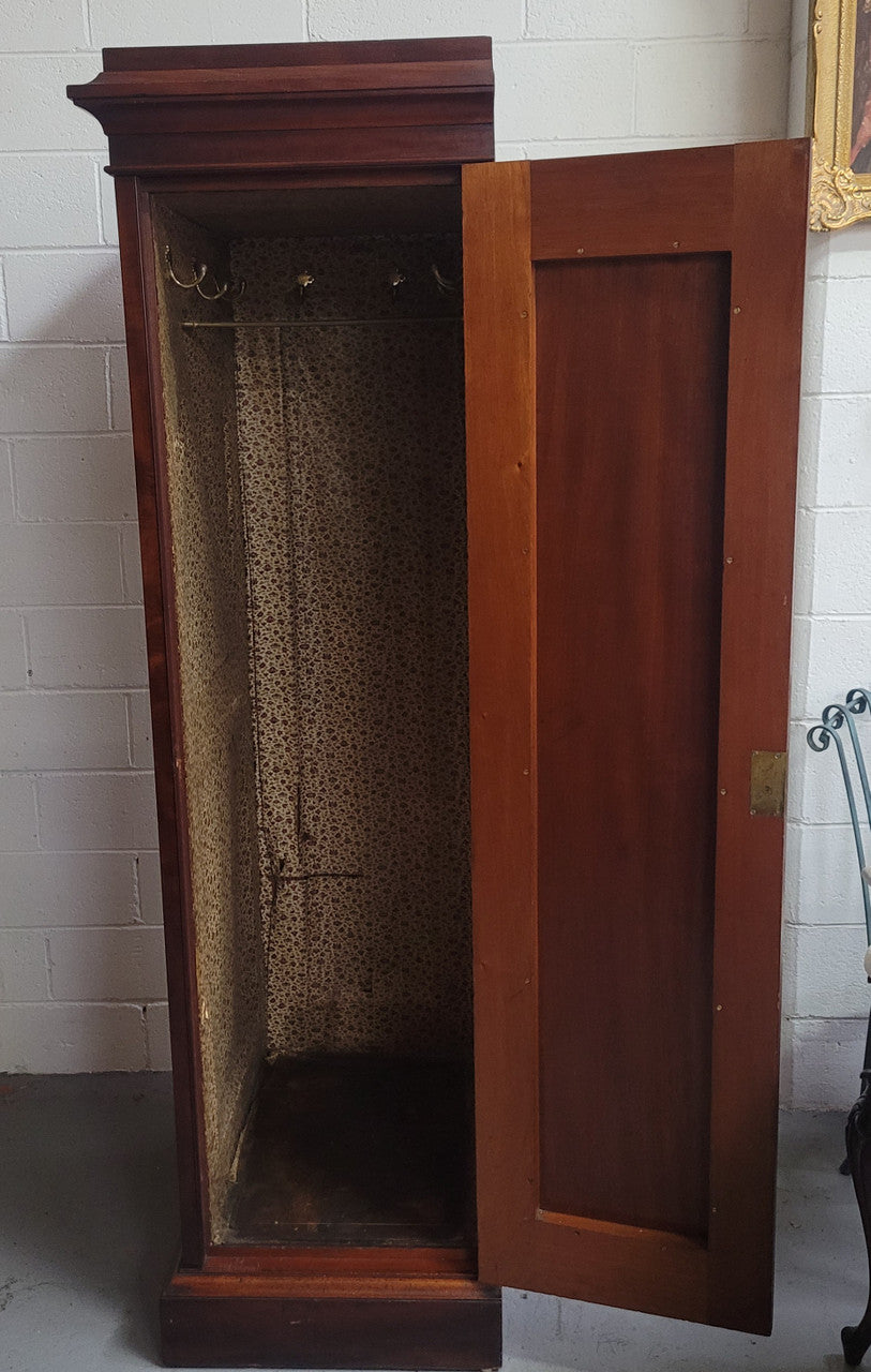 Unusual Victorian Flame Mahogany side wardrobe with side door. It has full hanging and six hooks. The wardrobe opens from a side door which can be locked with its key and has a markers mark stamp on the door. It is in good original condition.