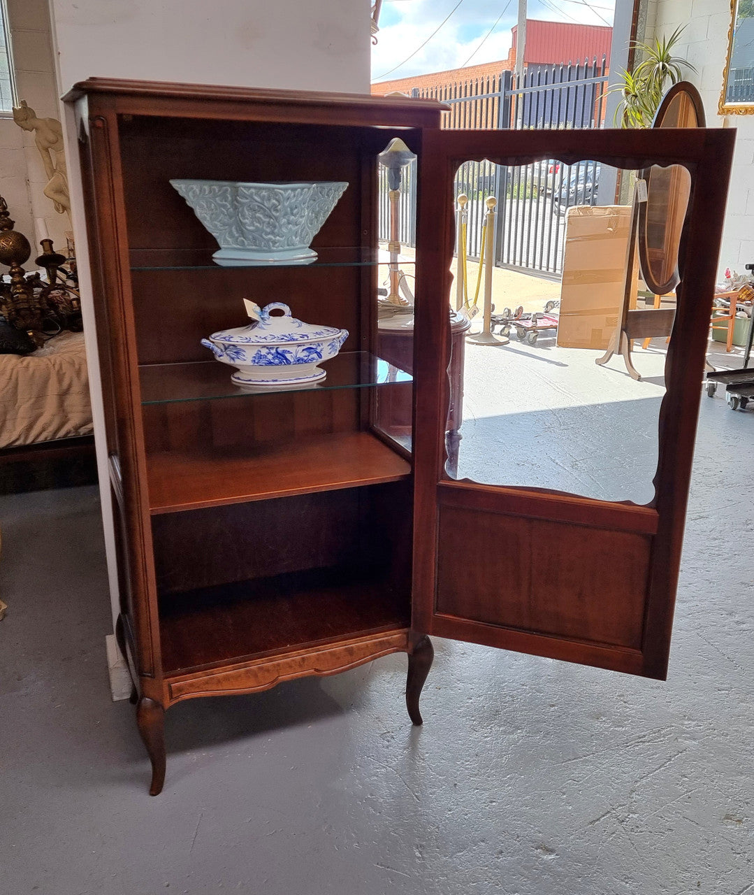 Petite French Louis XV style Walnut display cabinet with two glass shelves that can be adjusted and added storage at the bottom . In very good original detailed condition.