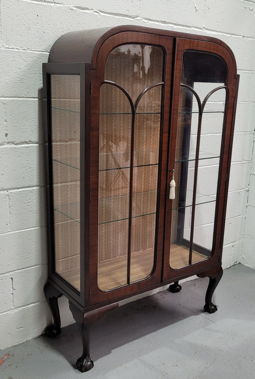 Chippendale style Walnut display cabinet of pleasing narrow portrions. It is in good original condition and comes with three shelves.