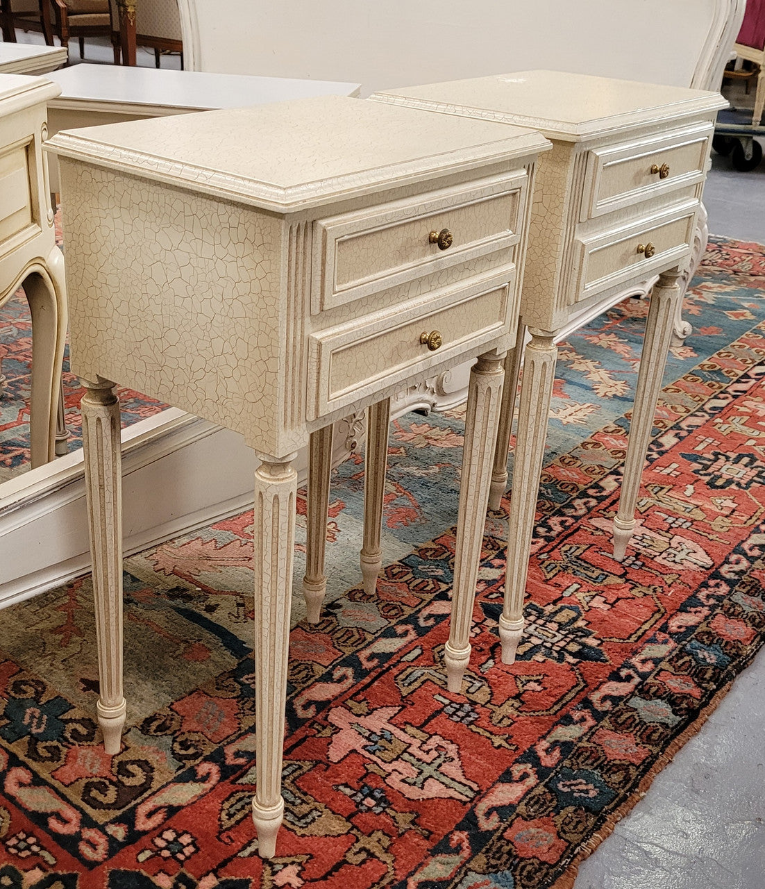Pair of Vintage Louis 16th style painted crackle finish two drawer French style bedsides. They have elegant reeded legs and have been sourced from France. They are in good original condition.