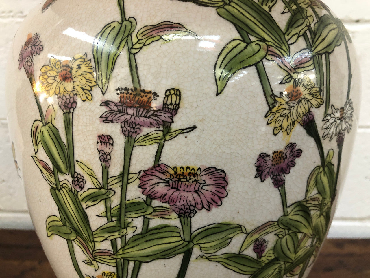 Contemporary ceramic lamp base decorated with daises & butterflies on a wooden base with shade.