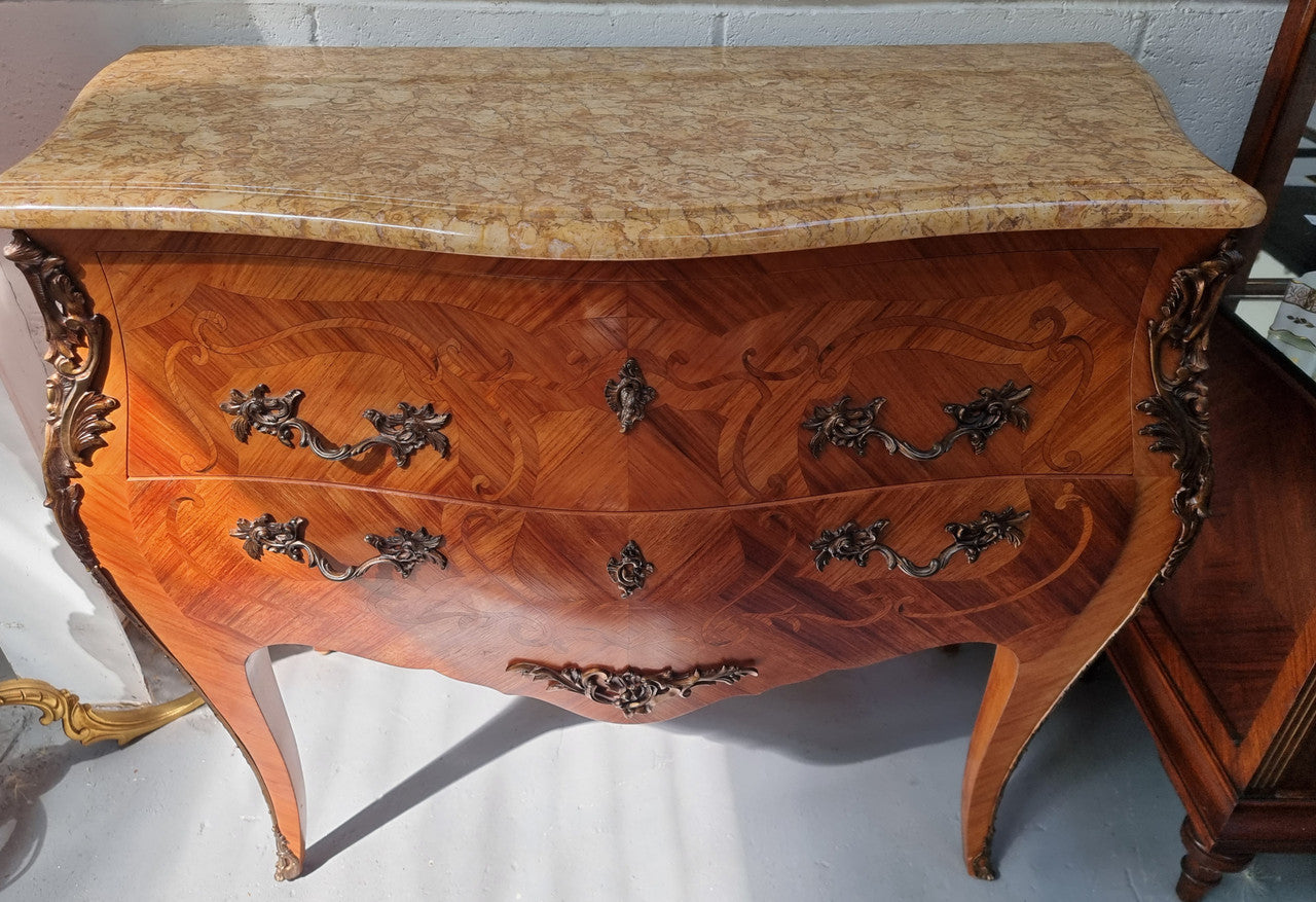 French marquetry inlaid Kingwood marble top commode. It has two drawers and beautiful mounts. Is in good original detailed condition.