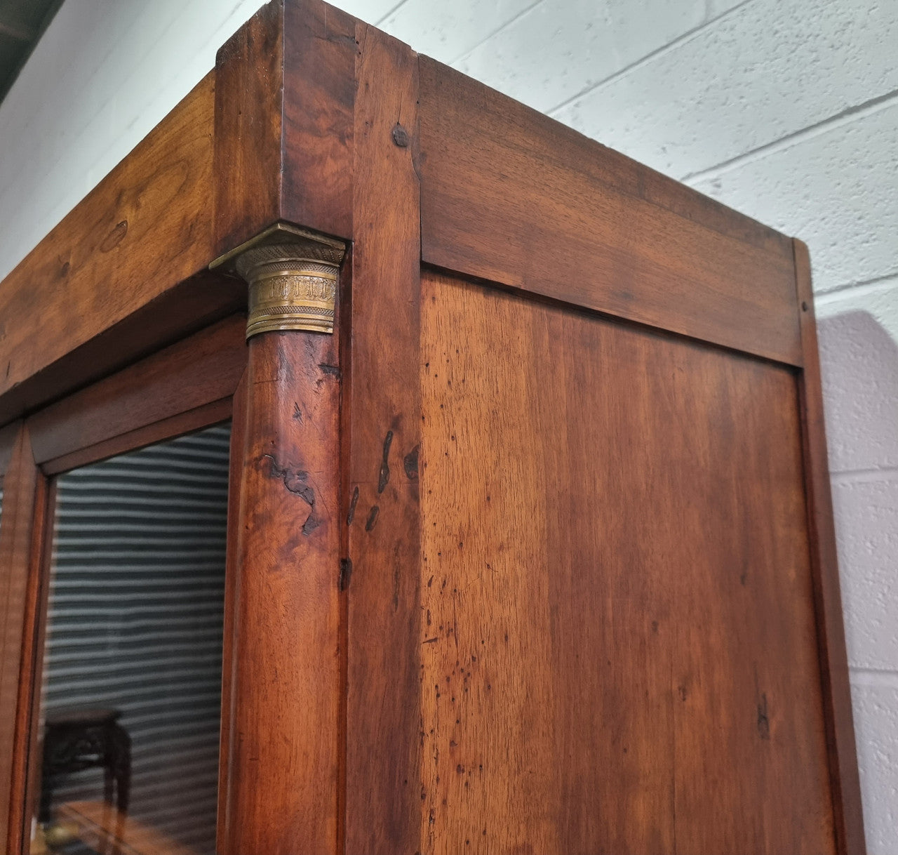 Grand French Mahogany Empire two door bookcase. It has beautiful glass doors and has three fully adjustable shelves. It has been sourced from France and is in good original detailed condition.