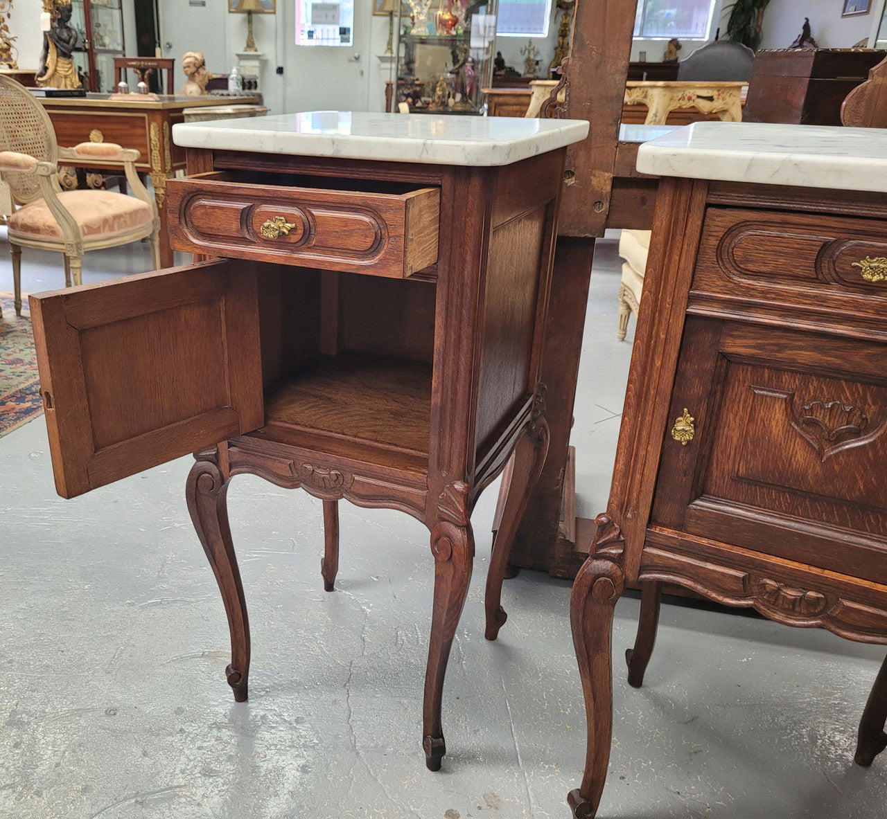 Pair French oak Louis XV style white carrera marble top bedside cabinets. Consisting of one drawer and one cupboard each on elegant legs. Circa: 1900's