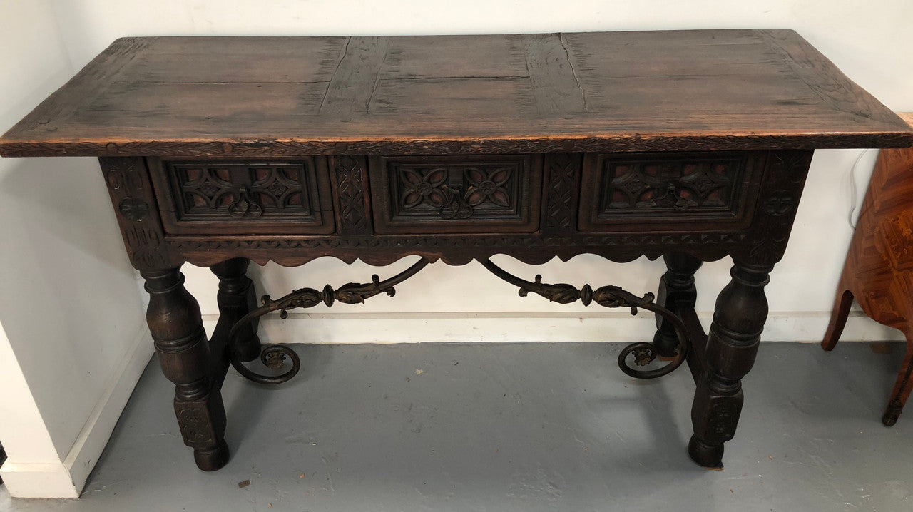 Spanish late 19th century carved oak three drawers console/side table. Superb wrought iron undercarriage. In good condition. Circa 1900's.
