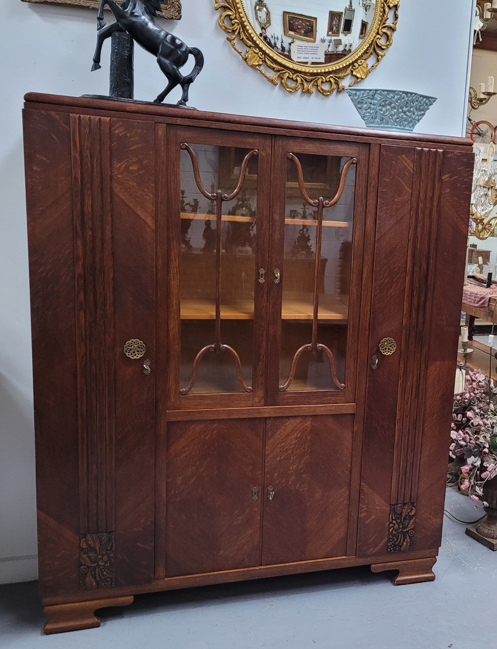 Stylish French Art Deco Oak bookcase with heaps of storage space and shelves. Middle section has two glass display doors. In good original detailed condition.