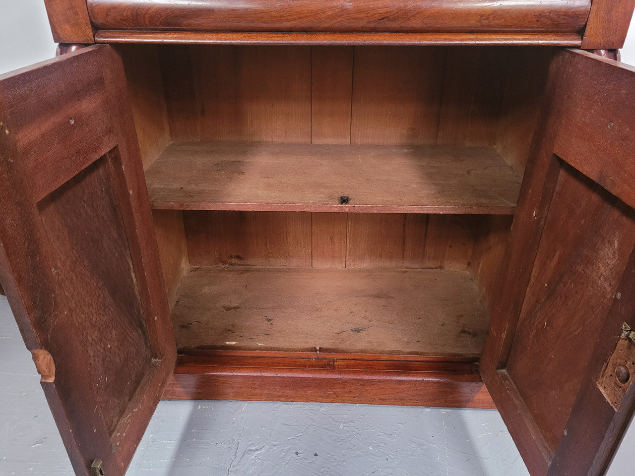 Cedar side cabinet with two doors one drawer and lovely door panels and corbels. It has been sourced locally and is in good original detailed condition.