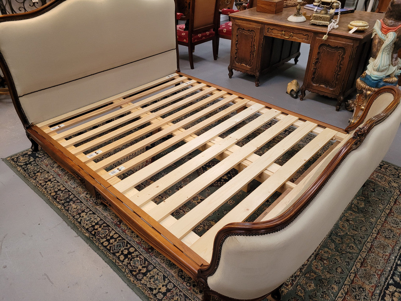 French Louis XV style queen size upholstered bed. Upholstery is in good condition and bed is complete with custom made slats. Just place your mattress on top.