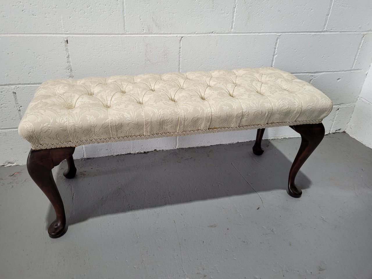 Vintage neutral upholstered buttoned stool. Fabric is in good used condition, please view photo's has they help form the description. The stool its self is in good condition.