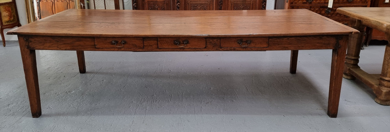 Amazing 19th Century French Oak Farmhouse style dining table with three drawers. It is made from three large planks of wood which is very hard to find. It is also very wide with a width of 105.5 cm. It is in good original detailed condition.