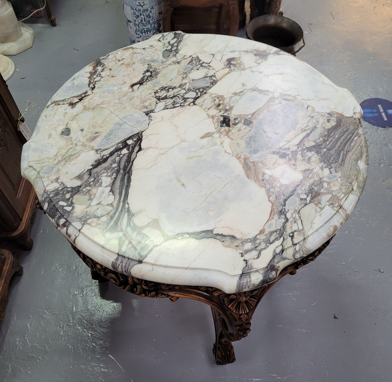 French Walnut Louis XV style round marble top centre table. It has amazing eye-catching marble, ornate detailed carvings and a beautifully carved undercarriage. In good original detailed condition.