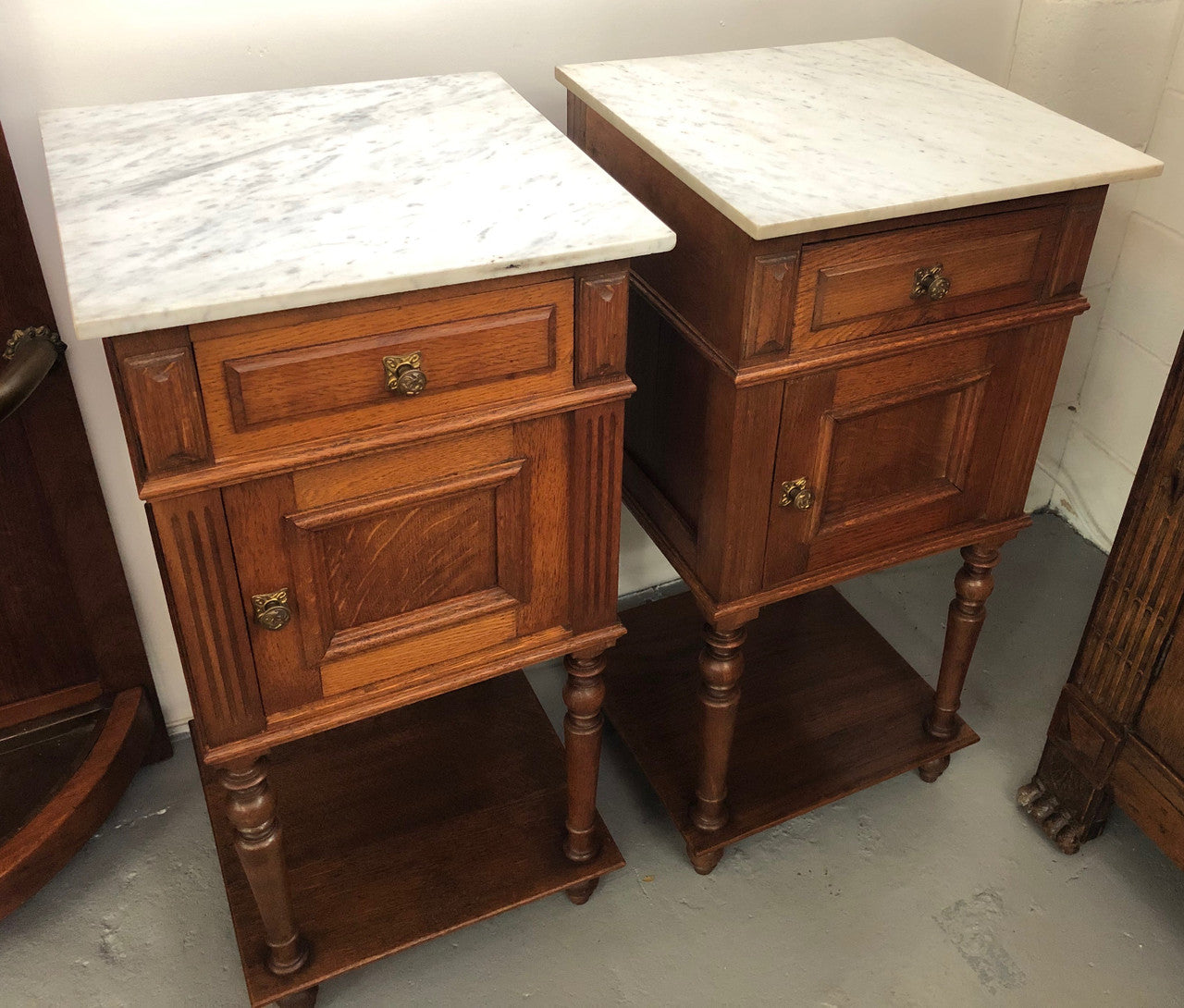 A lovely pair of French Oak, marble top bedside cabinets with a cupboard and drawer in good original condition.