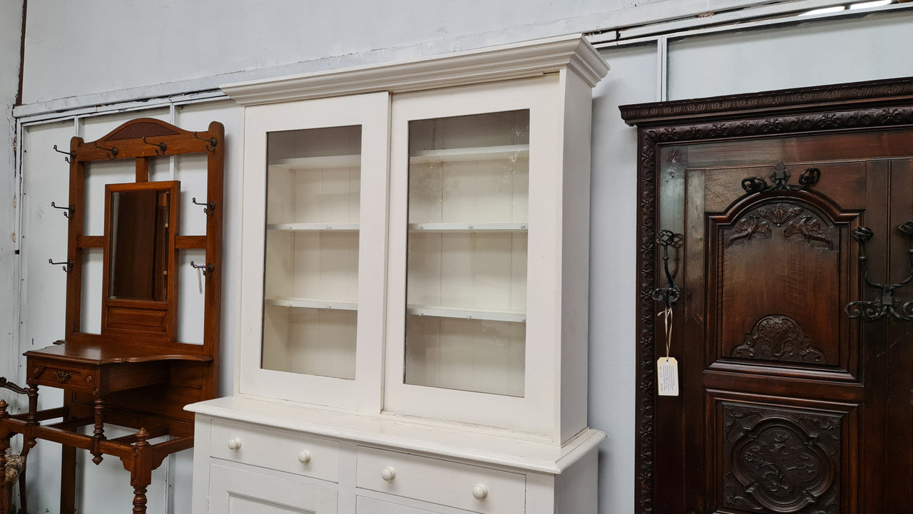 Australian painted two door kitchen hutch display and buffet cabinet. The top section has hooks and shelves. The bottom has two drawers along with cupboard space for added storage. In good original condition.