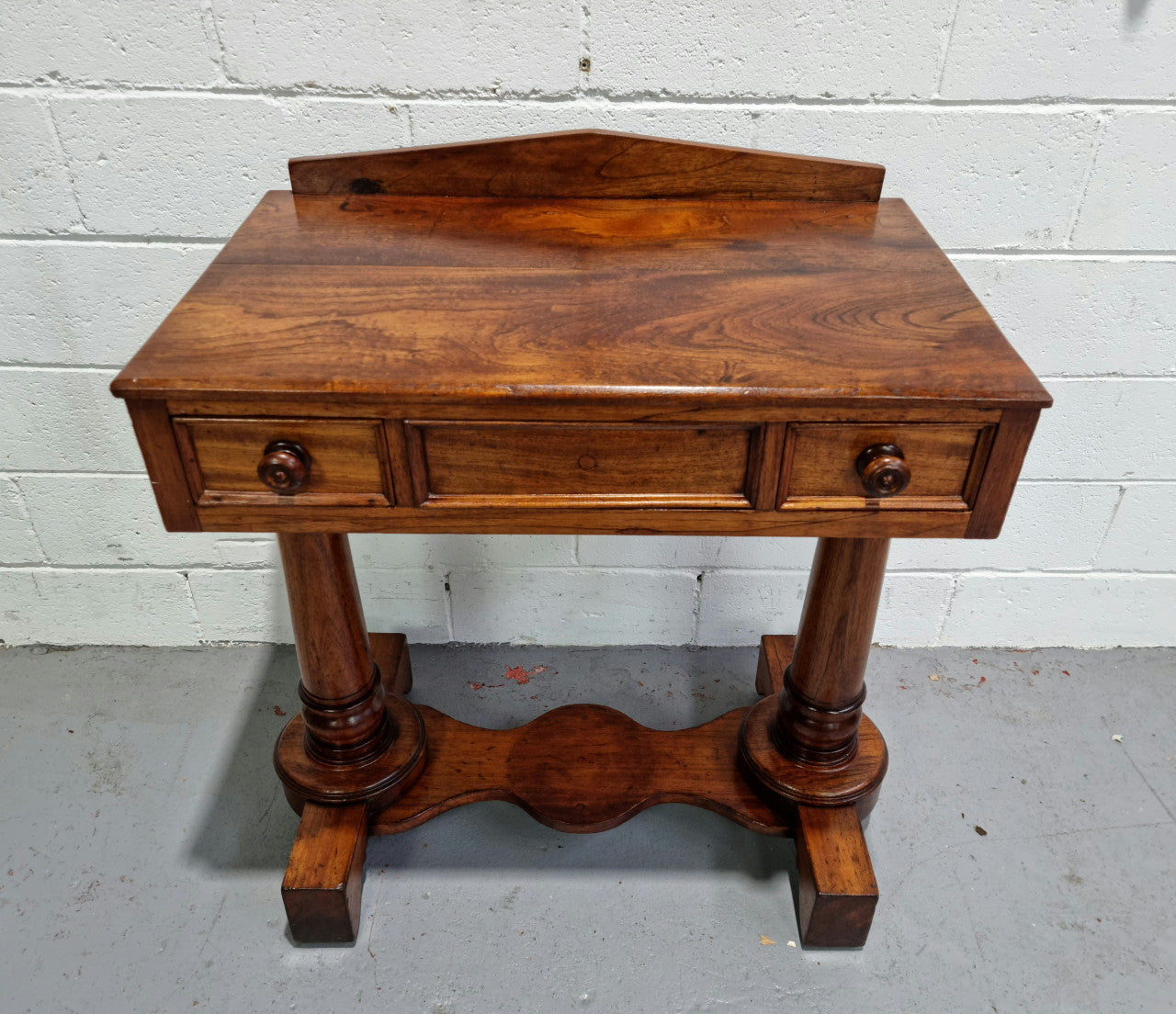 William IV style console table or could be used as a desk. It has two small drawers either side and is ideal for small areas like a unit or apartment. It is very sturdy and is in good original detailed condition.