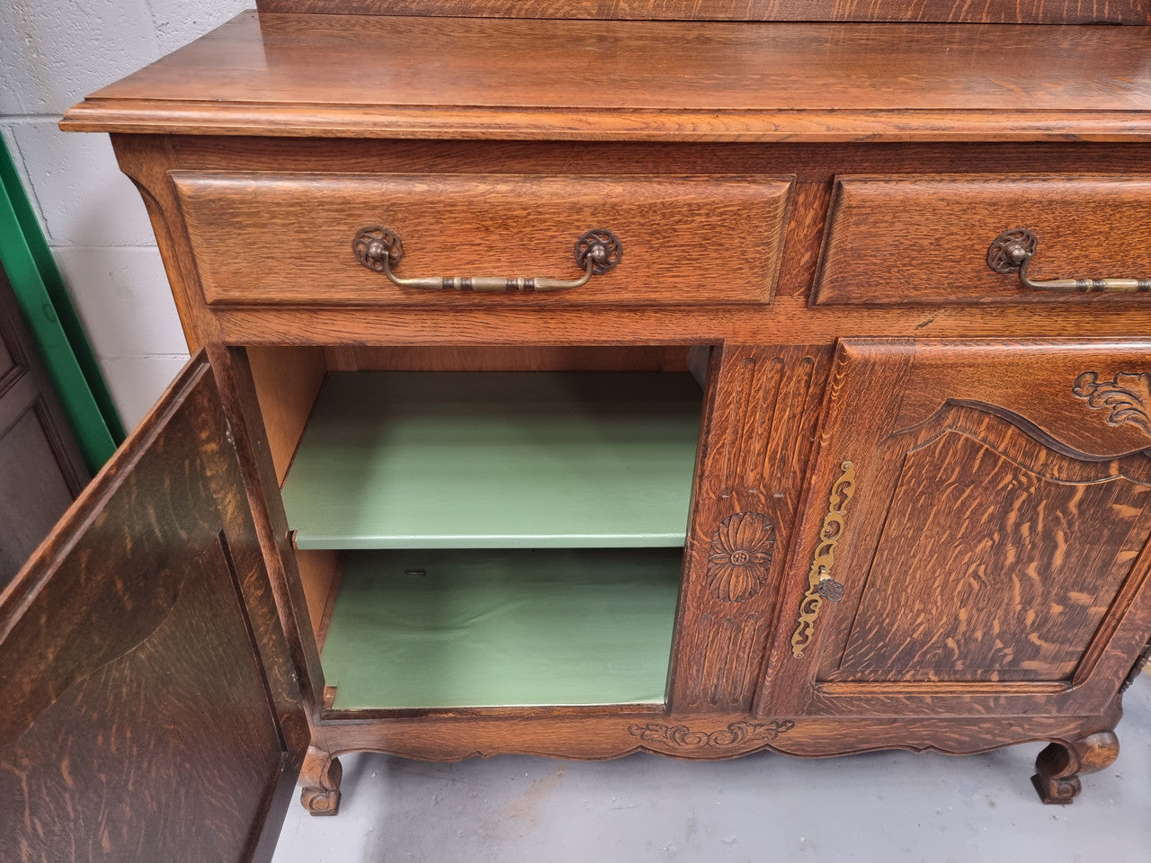 French Louis XV style Oak two door, two drawer sideboard. It is of pleasing narrow proportions and has one interior shelf. It has been sourced from France and it is in good original detailed condition.