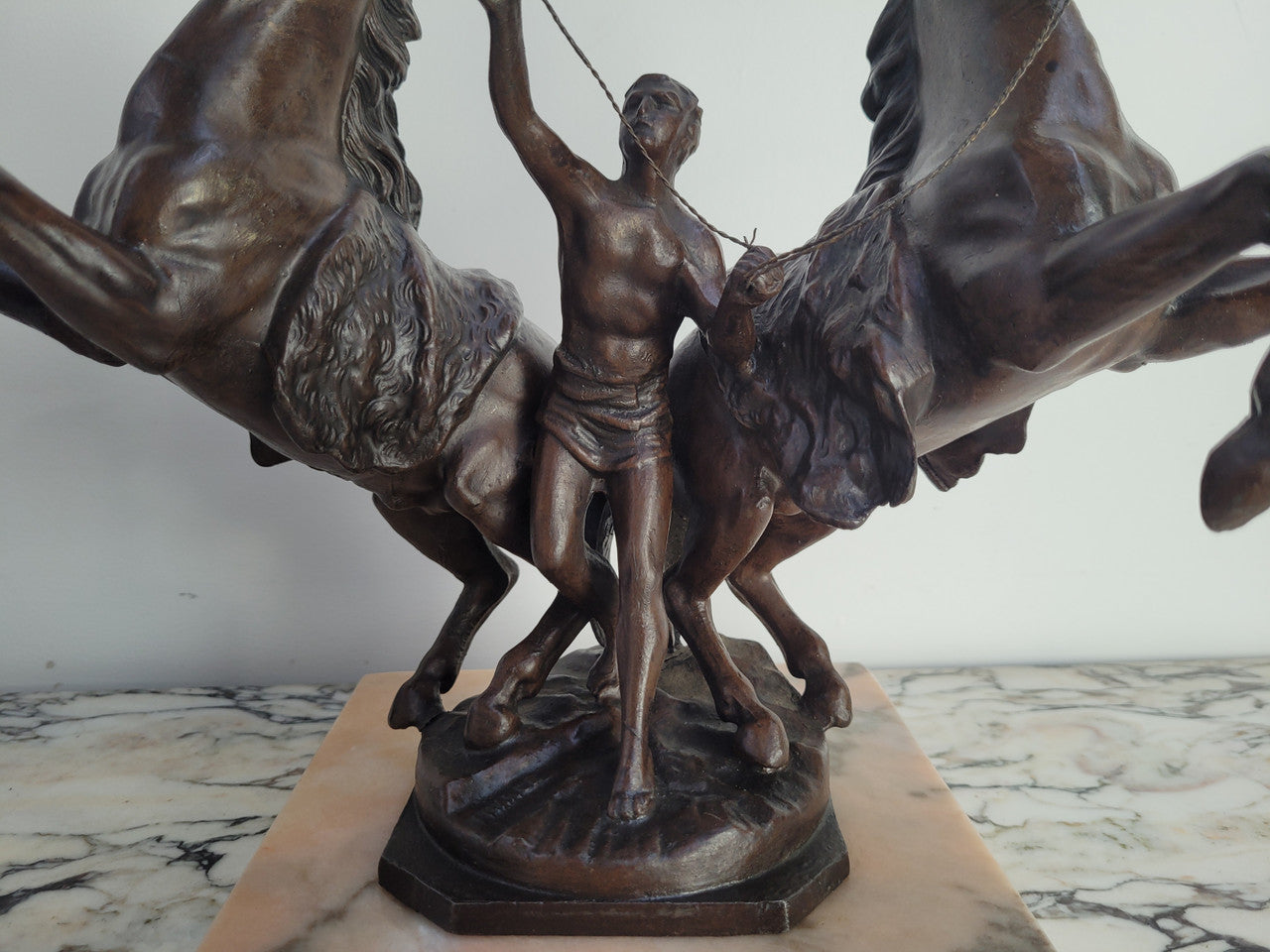 French Art Deco cold painted bronze metal marley horses style statue on a marble base. It is in good condition.