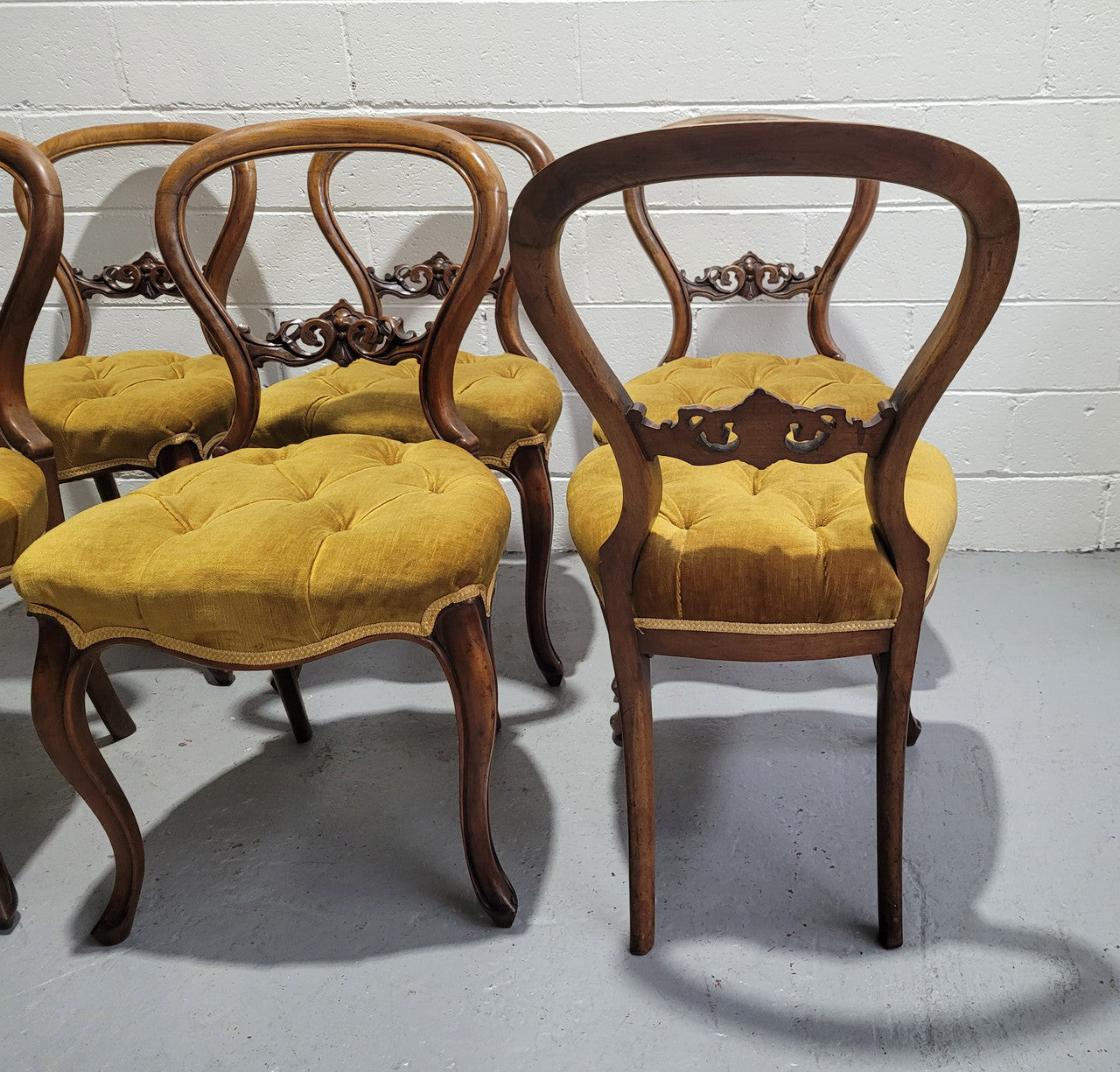 Set of six upholstered Victorian balloon back chairs. In good original detailed condition.