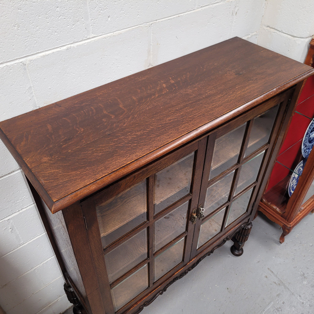 Tudor oak 2 door astral glaze and beveled glass bookcase. Good original condition. Circa 1930s.