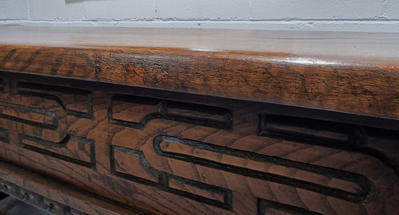 Rare and Charming 17th Century Spanish Walnut serving / side table. It has an incredible one piece walnut top with amazing character and colour. The base displays the original patina aswell as three drawers with carving and remnants of original locks. Superbly turned legs terminating on a stretcher base. Could be used as a large entrance console table, a side table or in a dining area as a serving table. In good original detailed condition especially considering its age.