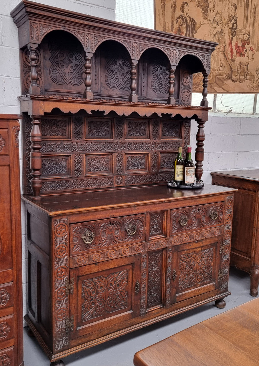 Impressively carved 18th Century English Oak kitchen dresser in 17th Century Jacobean style. It is in good original detailed condition and has been sourced from France.