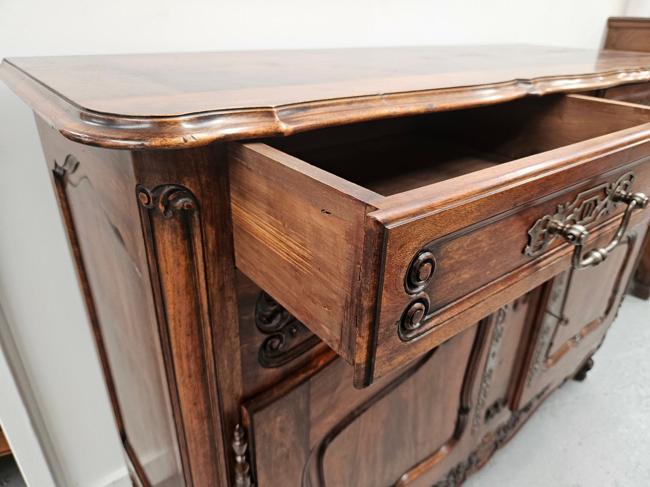 Attractive French Walnut Louis XV style two door two drawer sideboard featuring beautiful carving. Circa: 1930's. It has been sourced from France and it is in good original detailed condition.