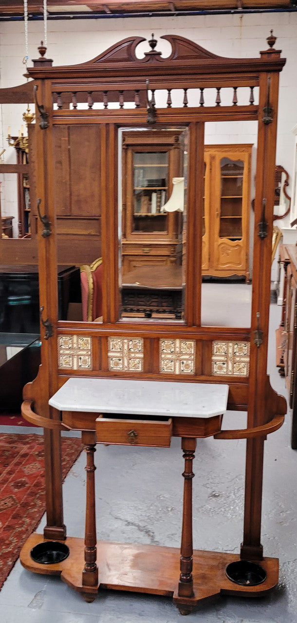 Late Victorian Arts and Crafts style marble top hall stand. Features three attractive tiles, original hooks and single drawer. In good original condition.