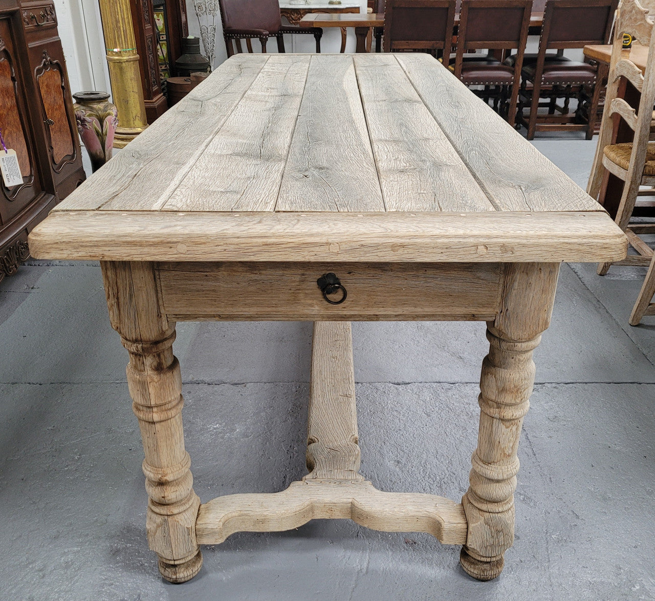 French stripped Oak pedestal stretcher base Farmhouse table with two drawers on either side of table. Features raw wood that could be used as is for a distressed look, or finished and waxed for a more refined look.