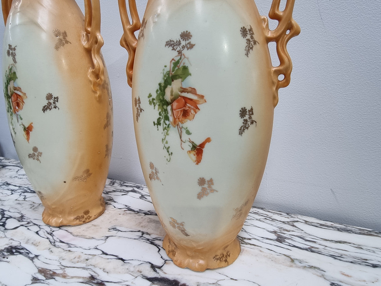 Decorative Pair of Art Nouveau Vases decorated with hand finished roses in muted tones. Gilt highlights. Impressed numbers to base. In good original condition, please view photos as they help form part of the description.