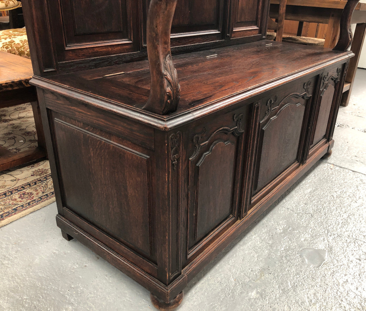 Beautifully carved French Oak hall seat with a lift up lid and storage space inside. In good original detailed condition.