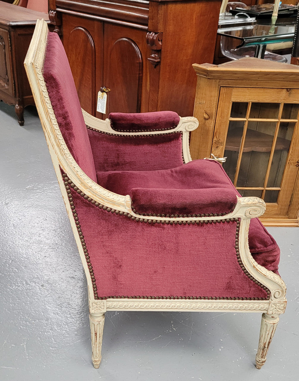Louis 16th Style high back upholstered chair with maroon velvet fabric, decorative carvings and original paint. It has been sourced from France and in good original condition.