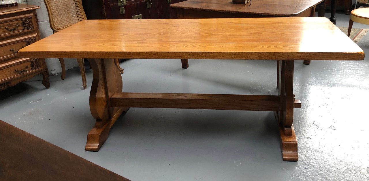 A French Style Oak stretcher base table with amazing wood grain. Can comfortable sit 6-8 people and is in original detailed condition.