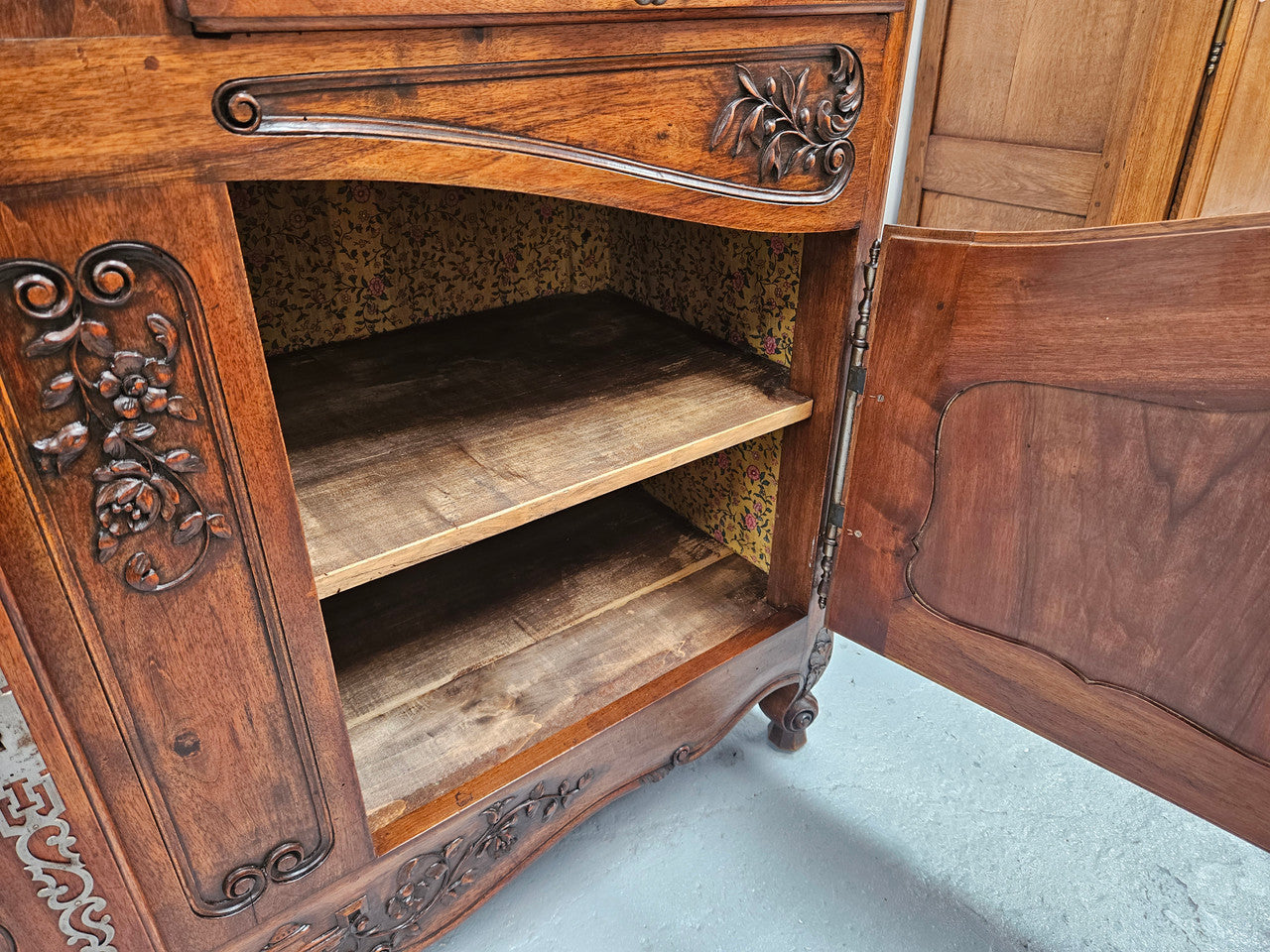 Attractive French Walnut Louis XV style two door two drawer sideboard featuring beautiful carving. Circa: 1930's. It has been sourced from France and it is in good original detailed condition.
