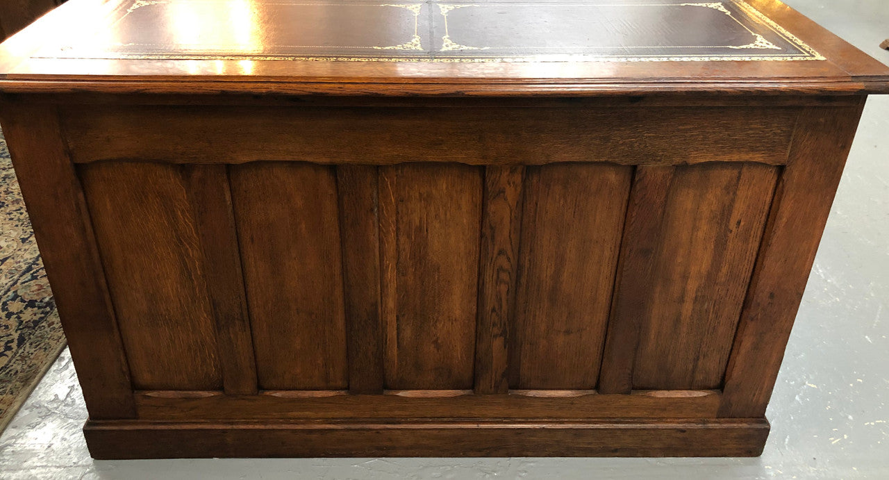 Lovely large English oak partners desk, with a beautiful burgundy tooled leather top. Plenty of storage space, both sides have 9 functioning drawers. It is in very good condition.