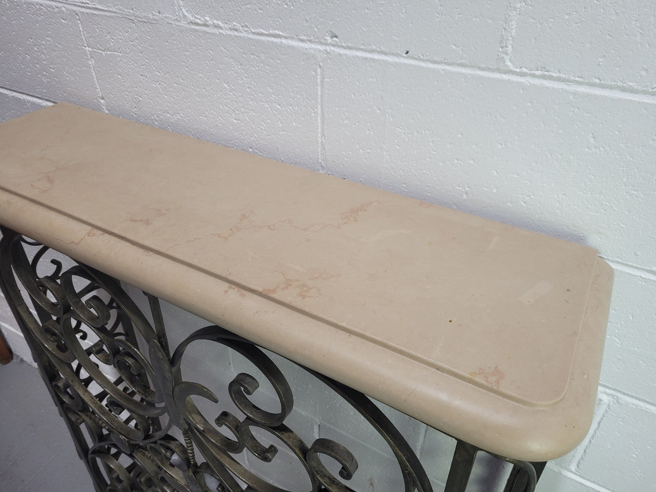 Stunning Art Deco wrought iron and marble top console table. It has amazing decorative iron work at the bottom and a beautiful marble top. It is in good original detailed condition.